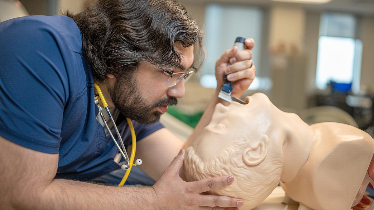 Respiratory Therapy Student examining a test dummy